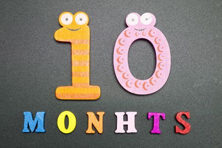 Ten months on a black background.の写真素材
