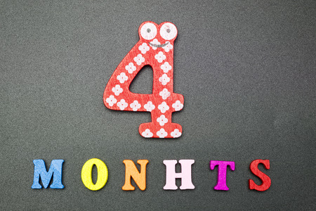 Four months on a black background.の写真素材