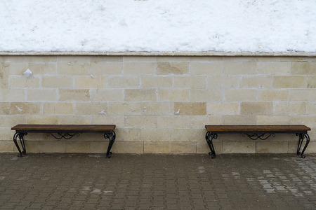 Benches standing against the wall.の写真素材