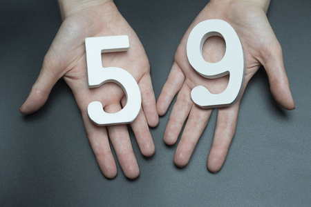 Female hand with number fifty-nine.の写真素材