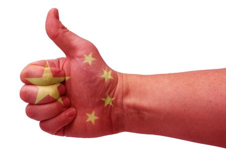 The concept of the hand gives a thumbs up with the flag of China.の写真素材