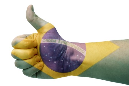The concept of the hand gives a thumbs up with the flag of Brazil.の写真素材
