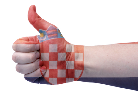 The concept hand gives a thumbs up with the flag of Croatia.の写真素材