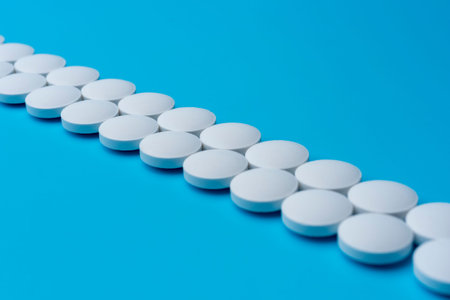 White medical pills on a blue background