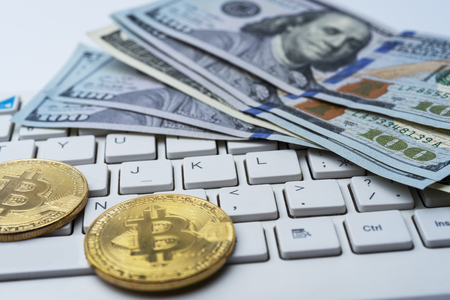 Bitcoin coin with keyboard and US dollars.の写真素材