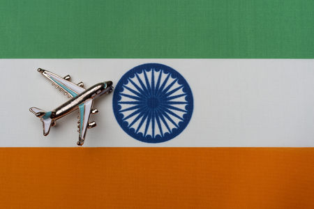 Plane over the flag of Indiaの写真素材