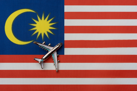 Plane over the flag of Malaysiaの写真素材