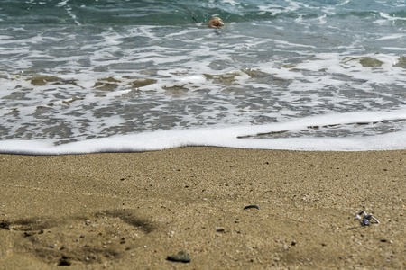 The sea waves splashing on a beachの写真素材