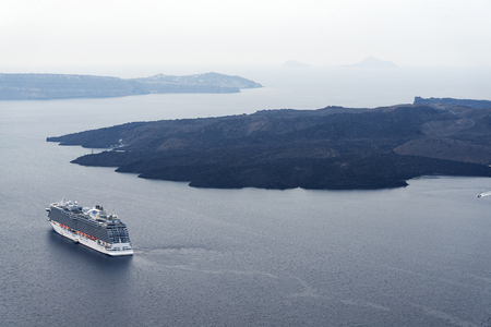 Cruise liner at the sea near the Nea Kameni, a small Greek island in the Aegean Sea near Santorini, cyclades, Greeceの写真素材