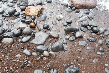 Beach with red sand in the island of Santorini.の写真素材