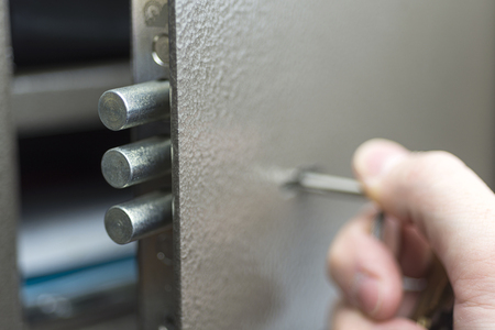 Hand opening the safe deposit box closeup photo.の写真素材