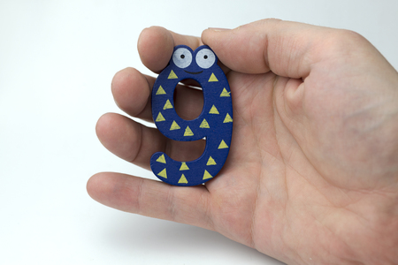 Hand holding number nine on white background.の写真素材