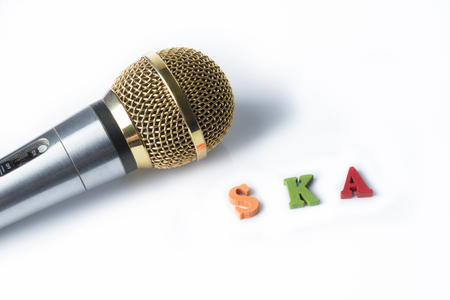 Microphone on a white background with the words ska of colorful letters.の写真素材