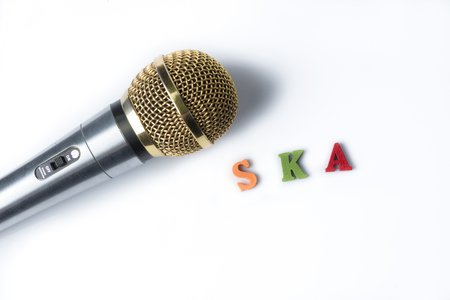 Microphone on a white background with the words ska of colorful letters.の写真素材