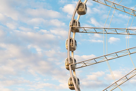 Large Ferris wheel on a blue sky background, close-up. The city of St. Petersburg amusement Park.