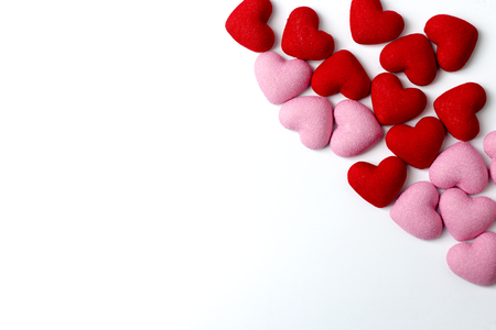 Lot of decorative red and pink hearts on a white background.の写真素材