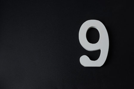 Number nine on a black isolated background.の写真素材