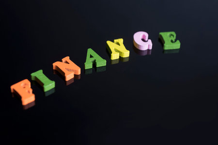 The word Finance of colored letters on black background.