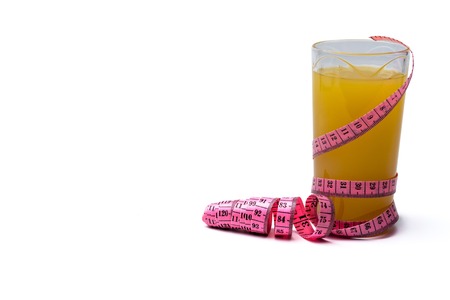 Measuring tape, glass of freshly squeezed orange juice. Images on white isolated background.の写真素材