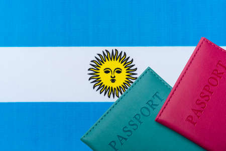 On the background of the Flag of Argentina lie the passport. Travel and tourism concept.の写真素材
