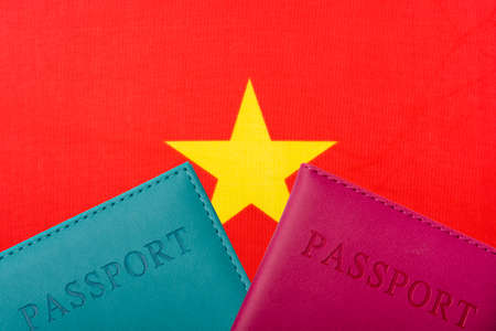 On the background of the Flag of Vietnam are passport. Travel and tourism concept.の写真素材