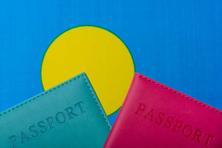 Against the flag of Palau two passports. The concept of travel and tourism.の写真素材