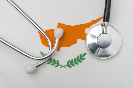 Cyprus flag and stethoscope. The concept of medicine. Stethoscope on the flag in the background.の写真素材