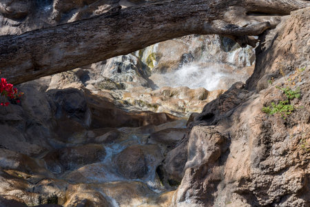 Water flows over the rocks in the Park. The concept of rest and tranquility.
