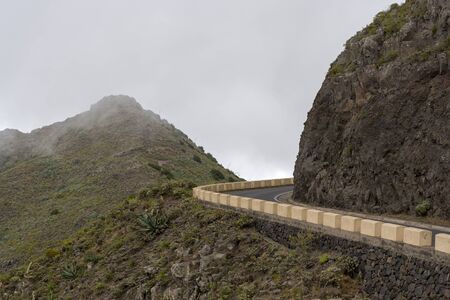 Mountain road on the island of Tenerife, high mountains and dense forests. The concept of tourism and recreation.の写真素材