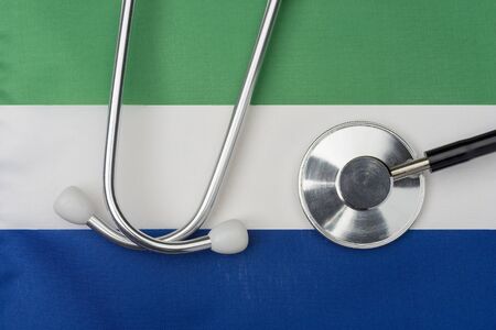 Sierra Leone flag and stethoscope. The concept of medicine. Stethoscope on the flag in the background.の写真素材