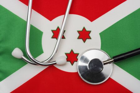 Burundi flag and stethoscope. The concept of medicine. Stethoscope on the flag in the background.の写真素材