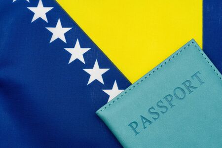 On the background of the flag of Bosnia and Herzegovina is a passport. The concept of travel and tourism.の写真素材