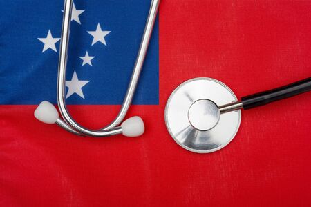 Concept of medicine with stethoscope on the flag of Samoa in the background.の写真素材