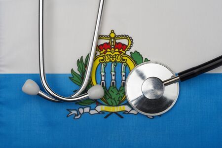 Concept of medicine with stethoscope on the flag of San Marino in the background.の写真素材