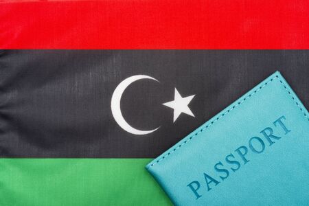 Against the background of the flag of Libya is a passport.の写真素材