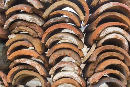 Red tiles for the roof of the building, close-up. The concept of building construction and roofs.の写真素材