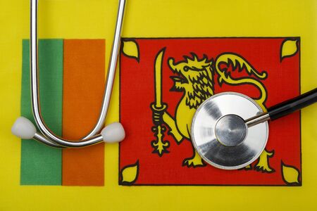 Flag of Sri Lanka and a stethoscope. The concept of medicine. Stethoscope on the flag in the background.の写真素材