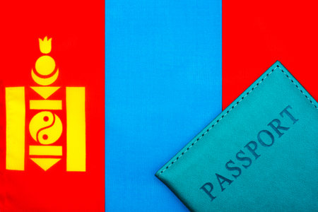 On the background of the flag of Mongolia is a passport. The concept of travel and tourism.の写真素材