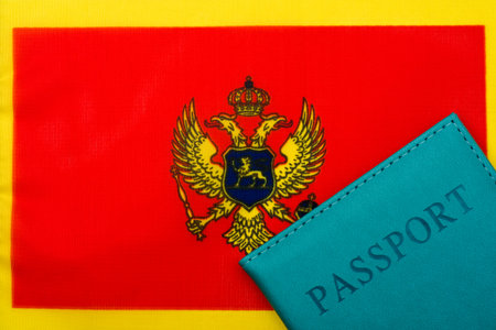 On the background of the flag of Montenegro is a passport. The concept of travel and tourism.の写真素材