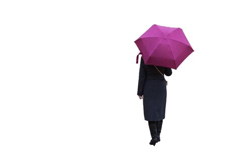 A girl with an umbrella on a white background is standing with her back. A girl in a coat and a pink umbrella.の写真素材