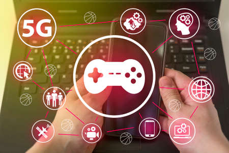 Joystick icon on the background of your computer and phone. The concept of the game on your phone or laptop.の写真素材