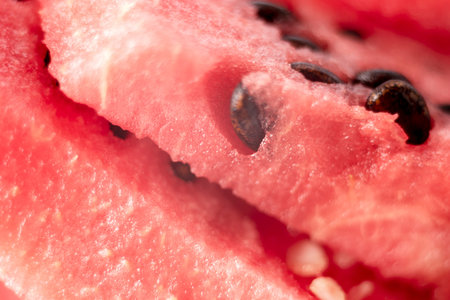 Watermelon texture close up. Background of Watermelon with seeds. Close up of juicy and sweet flesh...