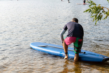 Standup paddleboarding are on the river Moscow, Strogino. The concept of a healthy lifestyle.