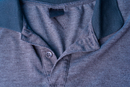 A Dark gray Polo shirt with a cotton collar and gray buttons. Clean dark gray fabric.