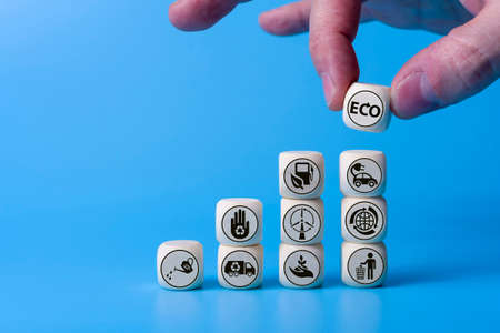 Ecology concept with icons on wooden cubes, blue background. The concept of clean energy for the whole world.の写真素材