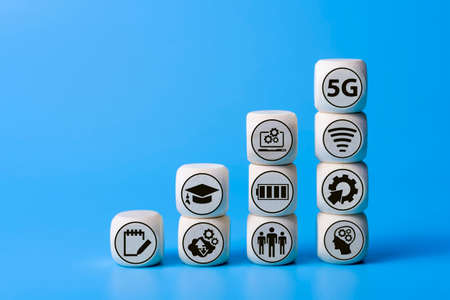 Concept of 5G with icons on wooden cubes. Blue background. The concept of technologies of the...