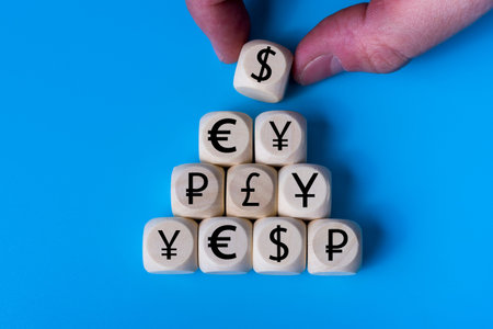 dollar, Euro, ruble concept with icons on wooden cubes, blue background. The concept of the world...