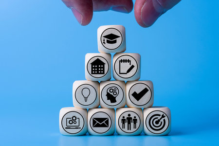 Education concept with icons on wooden cubes, blue background. The concept of success and work on...