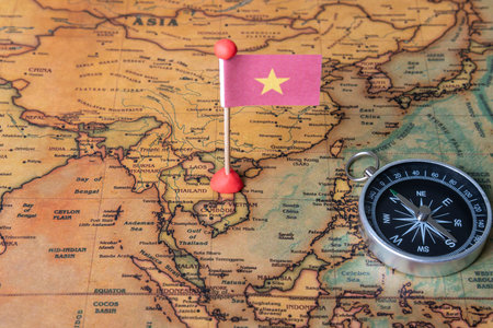 Vietnam flag and compass on the world map. The concept of travel and tourism.