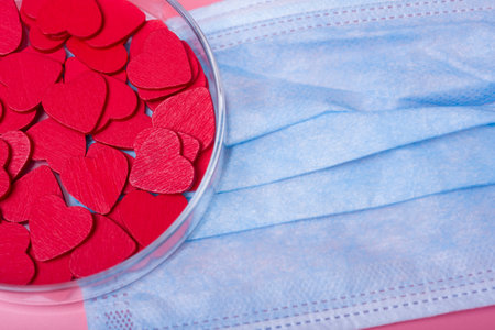 Heart in a petri dish on a pink background. The concept of love and happiness on Valentine's Day.の写真素材